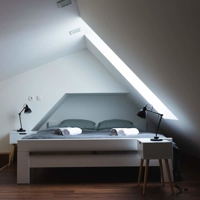 The sleeping area in the loft boasts a large and comfortable bed.
