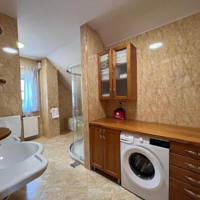 The large bathroom has a washing machine.