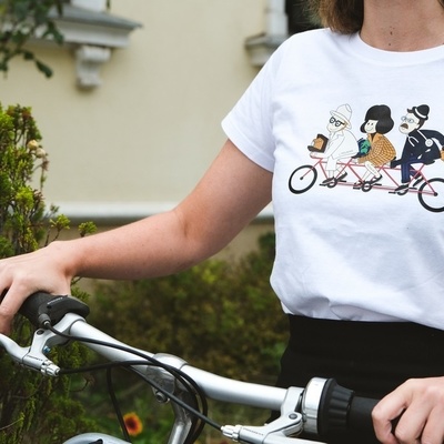 Spoil yourself with a cycling souvenir - a T-shirt with an illustration of photographer Josip Pelikan, world traveler Alma Karlin, and doctor and composer Gustav Ipavec.