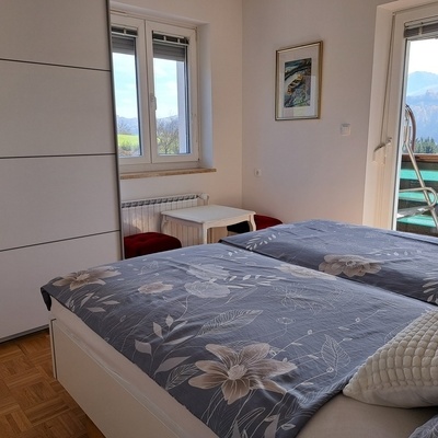 Udobna spalnica ima izhod na balkon.